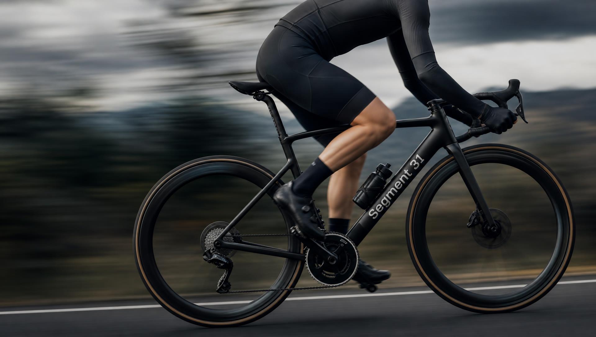 Road cyclist in motion on a dark speed-blur background, Segment 31 branded bike